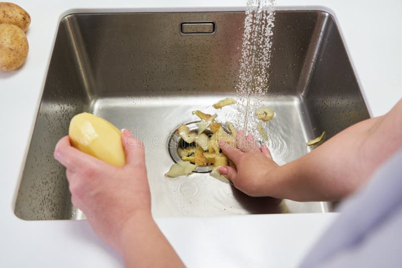 Food Waste Disposer Machine in Sink in Modern Kitchen Stock Image