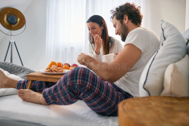 The food a young couple having for a breakfast in the bed at their bedroom is very delicious. Love, relationship, together