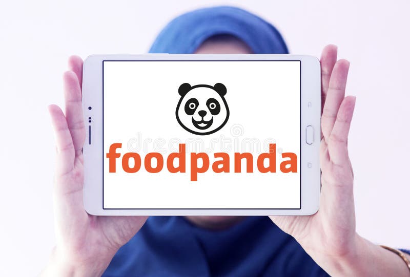 Logo of Foodpanda company on samsung tablet holded by arab muslim woman. Foodpanda is a German mobile food delivery marketplace. The service allows users to select from local restaurants and place orders via its mobile applications as well as its websites. Logo of Foodpanda company on samsung tablet holded by arab muslim woman. Foodpanda is a German mobile food delivery marketplace. The service allows users to select from local restaurants and place orders via its mobile applications as well as its websites