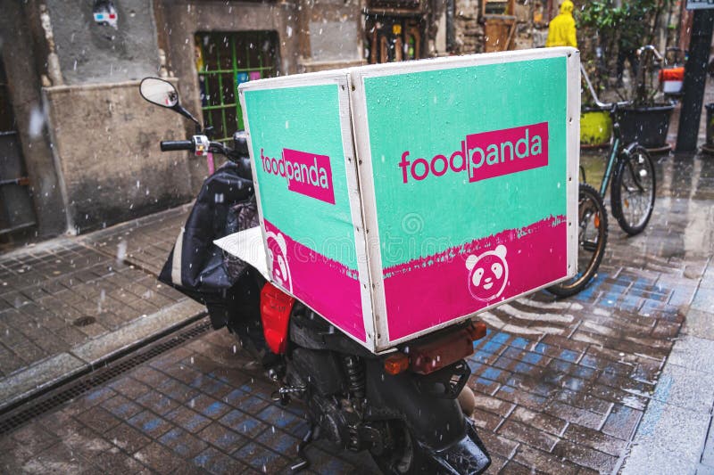 FoodPanda Food Delivery company service logo on a blue and pink box on a scooter in Winter. No people. Budapest, Hungary - February 2, 2023. FoodPanda Food Delivery company service logo on a blue and pink box on a scooter in Winter. No people. Budapest, Hungary - February 2, 2023.