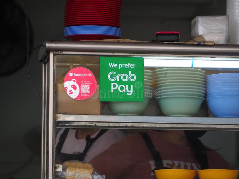 Foodpanda and Grab Pay stickers pasted on the glass window of a food stall at a coffee shop in Malaysia. Foodpanda and Grab Pay stickers pasted on the glass window of a food stall at a coffee shop in Malaysia
