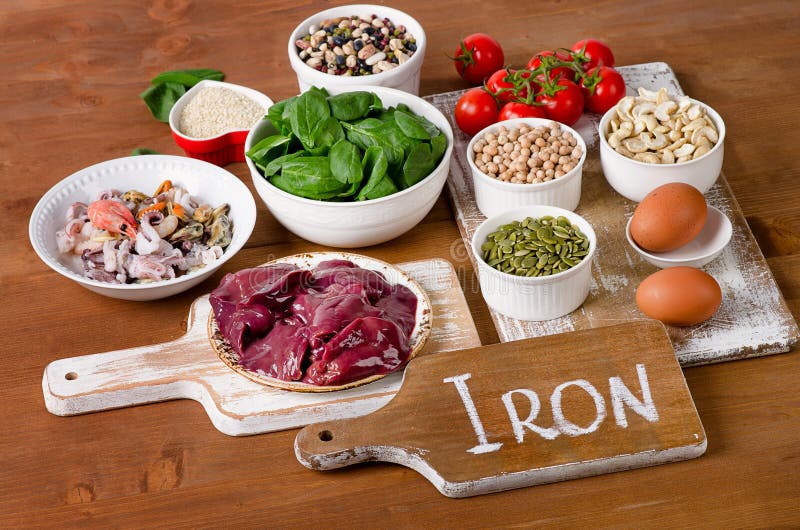 Foods high in Iron, including eggs, nuts, spinach, beans, seafoo. Foods high in Iron. Top view royalty free stock images