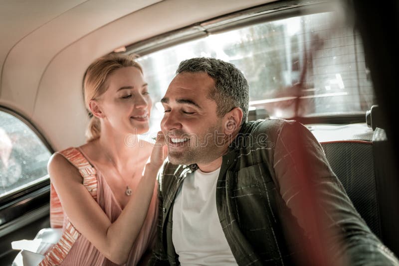 Smiling woman tickling neck of her husband. stock photo Smiling woman tickling neck of her husband. stock photo