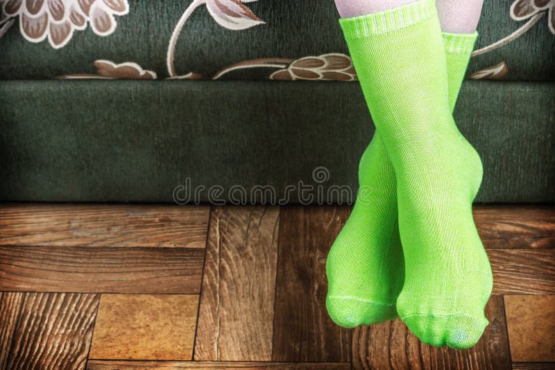 Foot overhang from the sofa in green socks