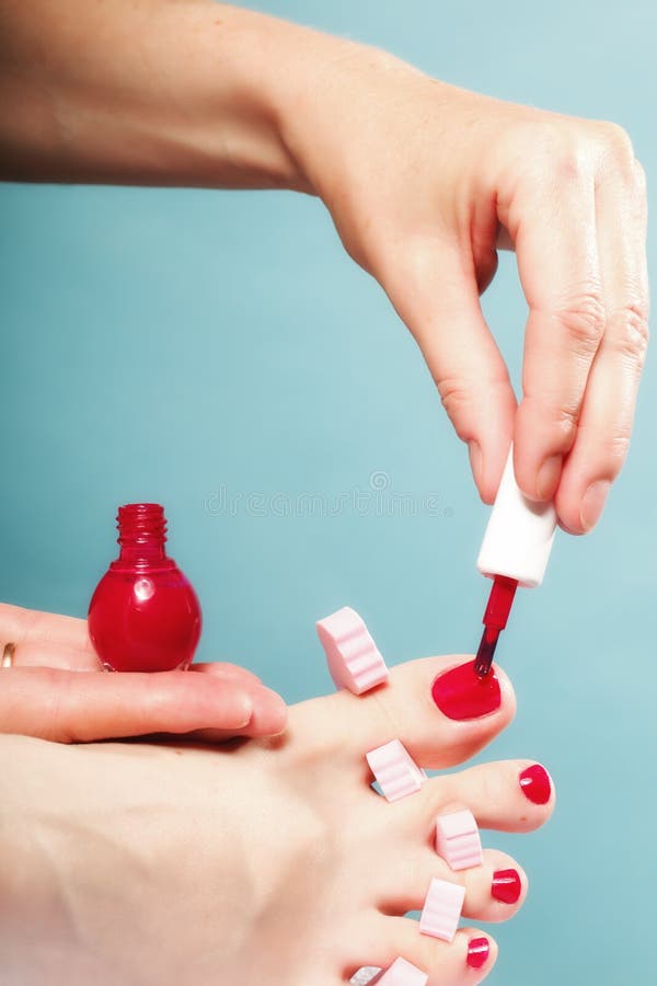 Foot Pedicure Applying Red Toenails On Blue Stock Image - Image of ...