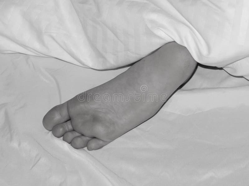 A Foot Peeking from Under the Covers Stock Photo Image of skin
