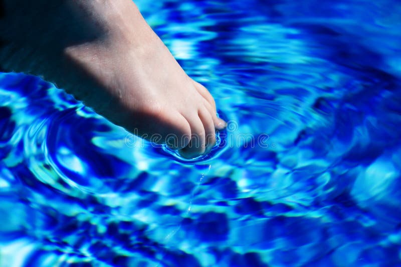 Foot in blue water. Foot in blue water