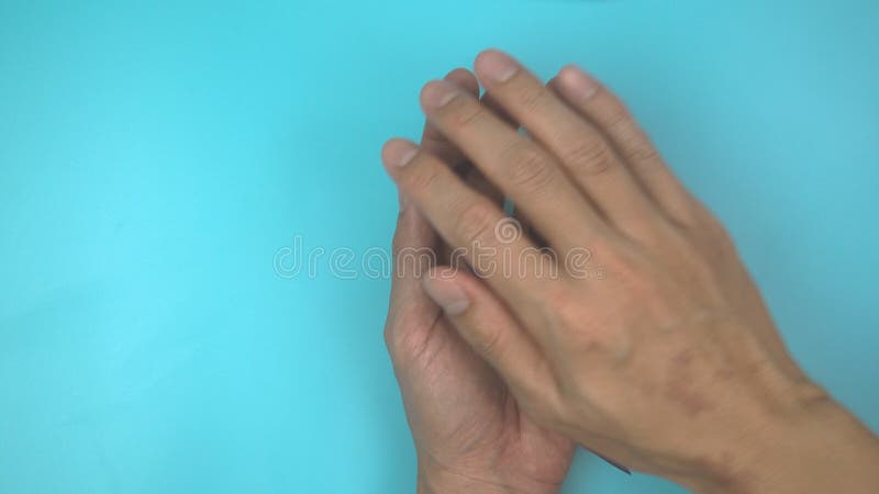 Footage video 4k. Hands holding purple or violet ribbon on blue. stock video footage