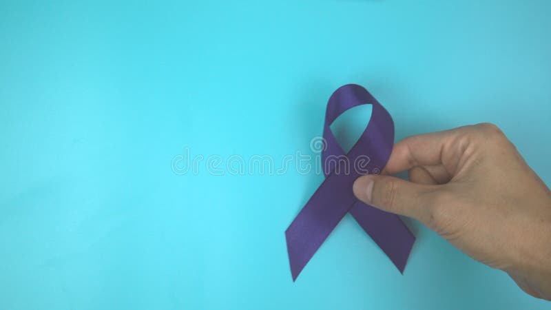 Footage video 4k. Hands holding purple or violet ribbon on blue. stock video
