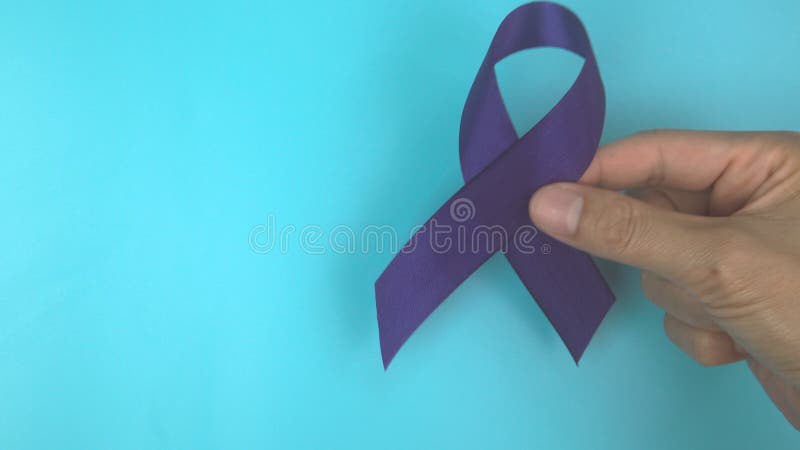 Footage video 4k. Hands holding purple or violet ribbon on blue. stock video