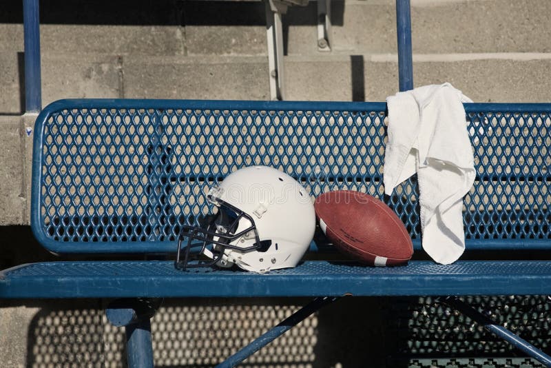 Football Helmet on a bench royalty free stock images
