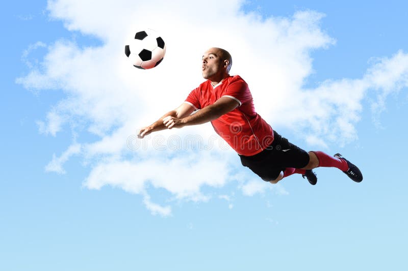 Football player in action jumping for head kick isolated on blue sky royalty free stock images Football player in action jumping for head kick isolated on blue sky royalty free stock images