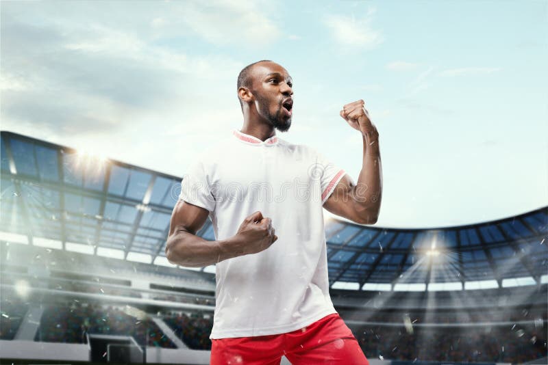 The Football Player in Motion on the Field of Stadium Stock Photo ...