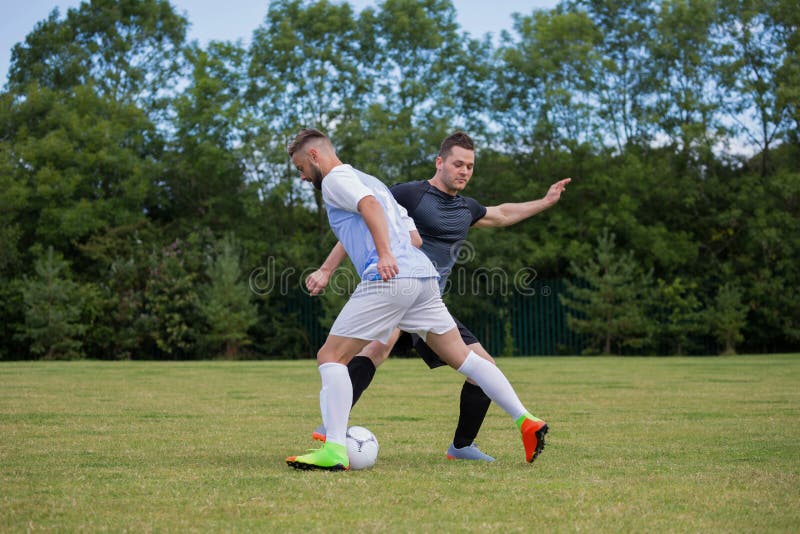 Football Players Playing Soccer in the Ground Stock Photo - Image of