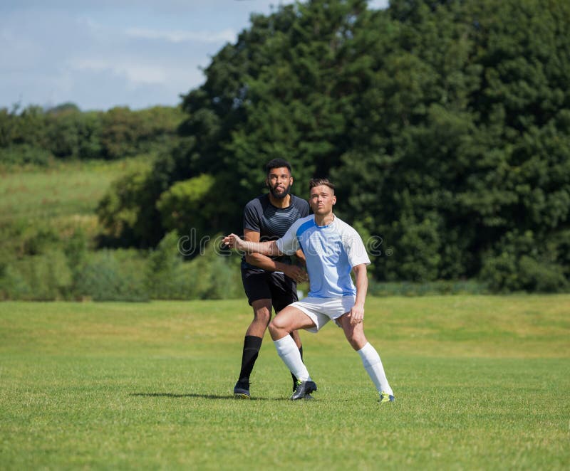 Football Players Playing Soccer in the Ground Stock Photo - Image of