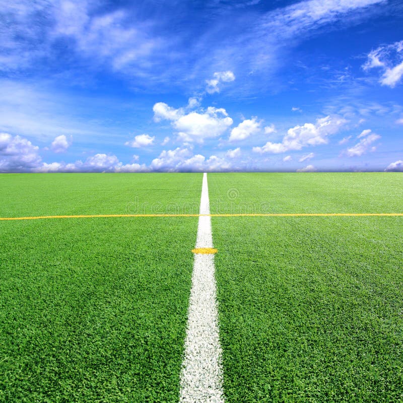 Football and Soccer Field Grass Stadium Blue Sky Background Stock Photo