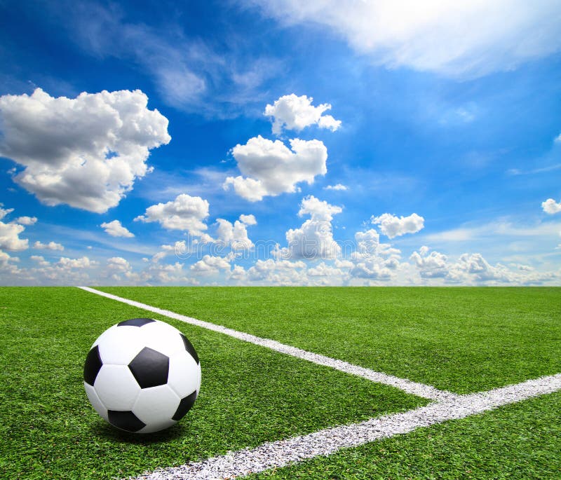 Football and soccer field grass stadium Blue sky background