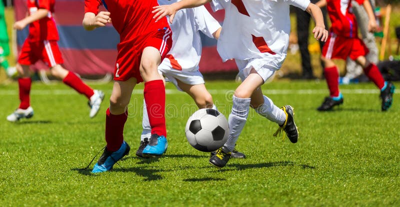 Football Soccer Kick. Soccer Players Duel. Children Playing Football Game on Sports Field. Boys Play Soccer Match on Green Grass