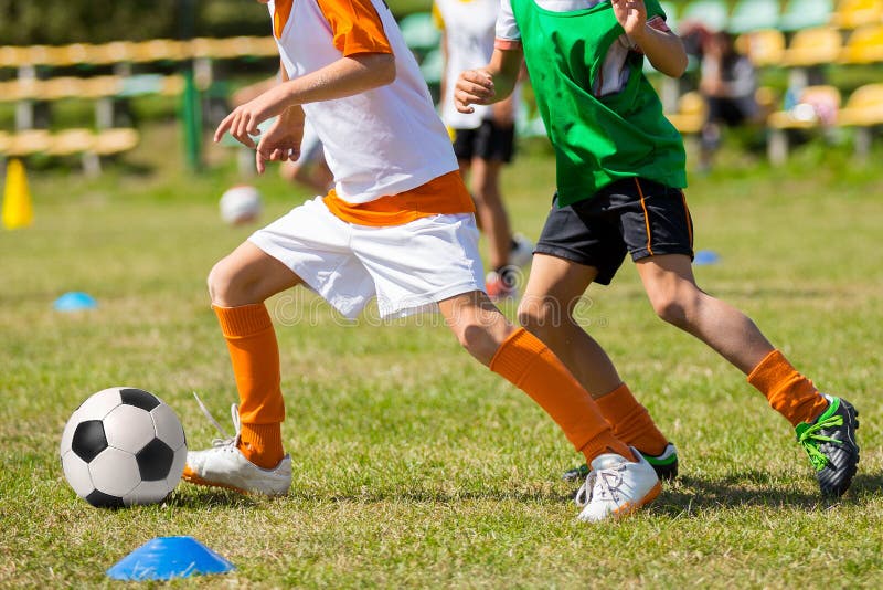 Children Playing Soccer Ball on Grass Field. Football Competition Between Two Kids stock images Children Playing Soccer Ball on Grass Field. Football Competition Between Two Kids stock images