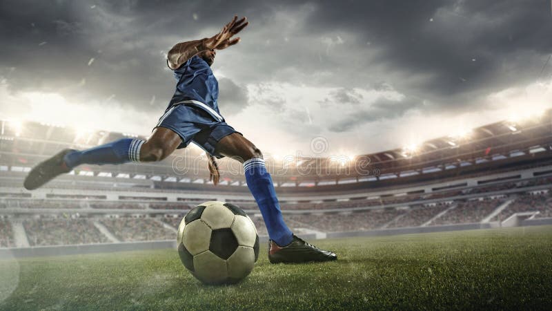 Football or soccer player in action on stadium with flashlights, kicking ball for winning goal, wide angle