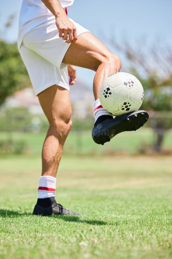 Football, Soccer Player and Balance Ball on Foot on a Grass Field