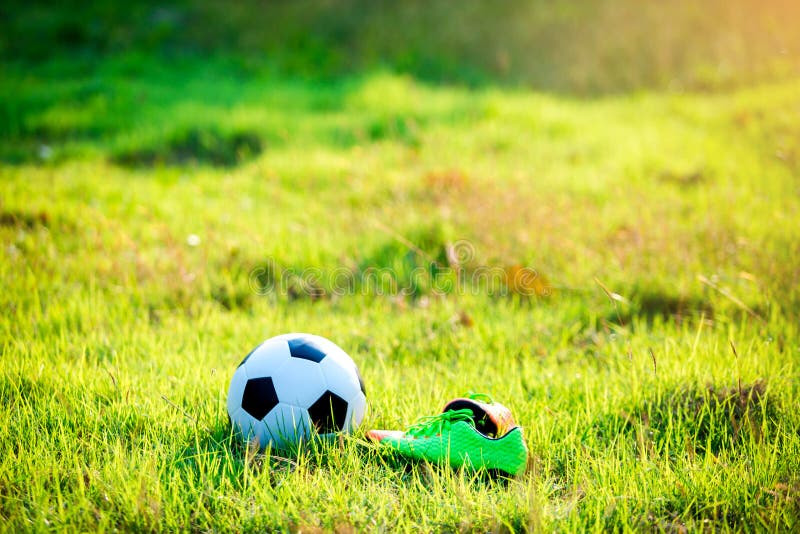 Football and Soccer Shoes on the Green Grass for Soccer Player Training ...