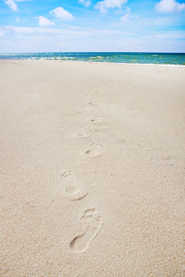 Footprints on empty beach