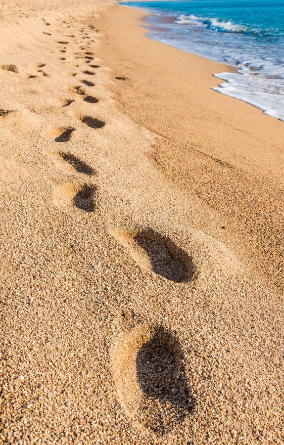 Footprints on sand beach.