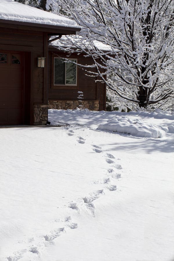 Footprints in snow after a winter storm in a mountain community stock image