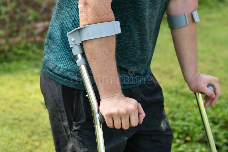 Man with Forearm Crutches. Hiker after Hard Walk Achieved Mountain Peak