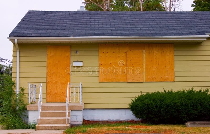 A house in good condition with the door and windows boarded up with plywood. A house in good condition with the door and windows boarded up with plywood.