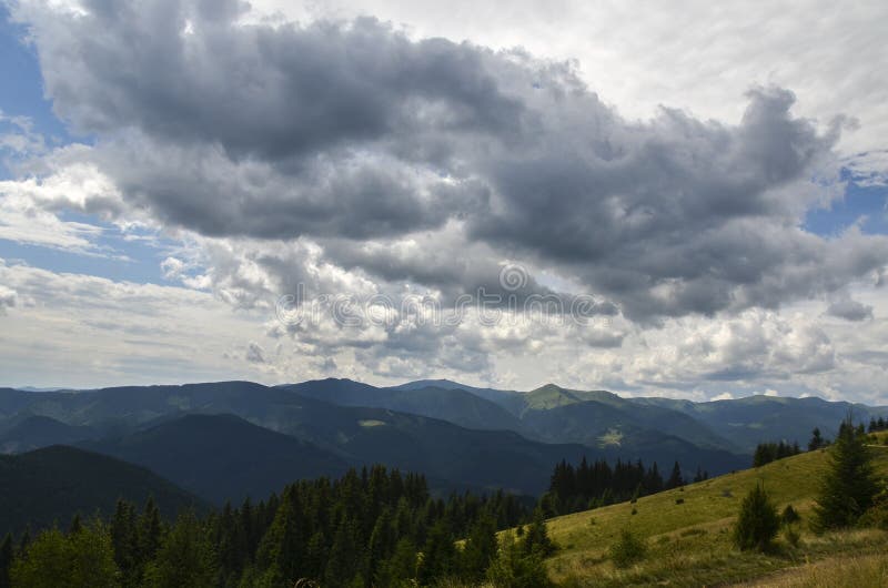 Green trees and rolling hills covered in dense forests with multiple layers of mountain ridges stock photos