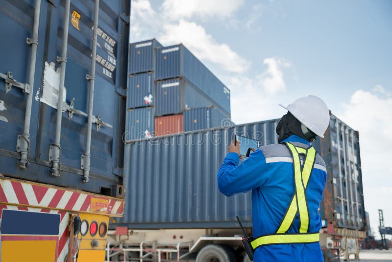 Foreman control loading Containers box from Cargo freight truck stock photography Foreman control loading Containers box from Cargo freight truck stock photography
