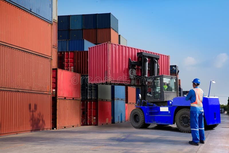 Foreman control loading Containers box from Cargo freight ship