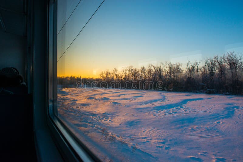 Forests and fields in the rays of dawn through the window of a speeding train stock photography Forests and fields in the rays of dawn through the window of a speeding train stock photography
