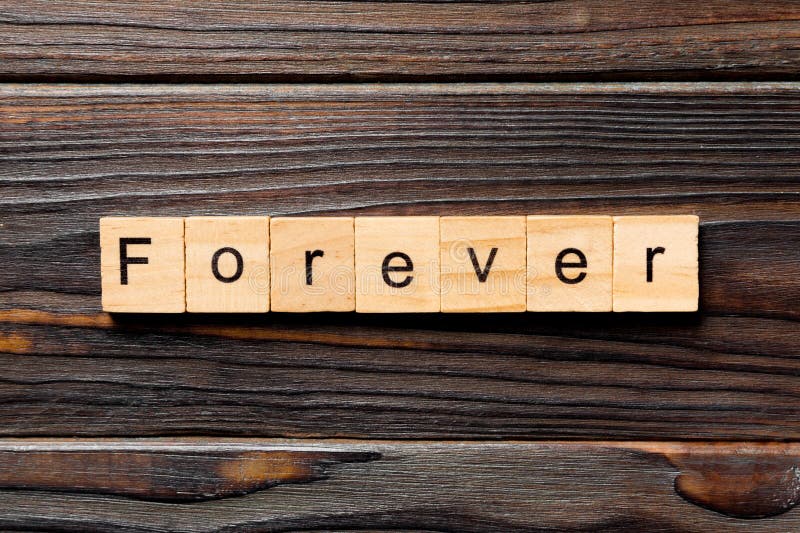 FOREVER Word on Wooden Cubes on Wooden Floor. Eternal Love or