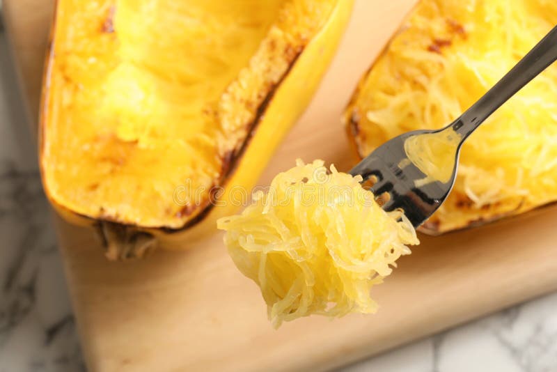 Fork With Flesh Of Cooked Spaghetti Squash On Blurred Background Stock
