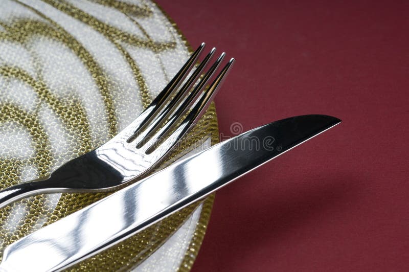 Fork and knife on a plate stock photo. Image of metal 16791186
