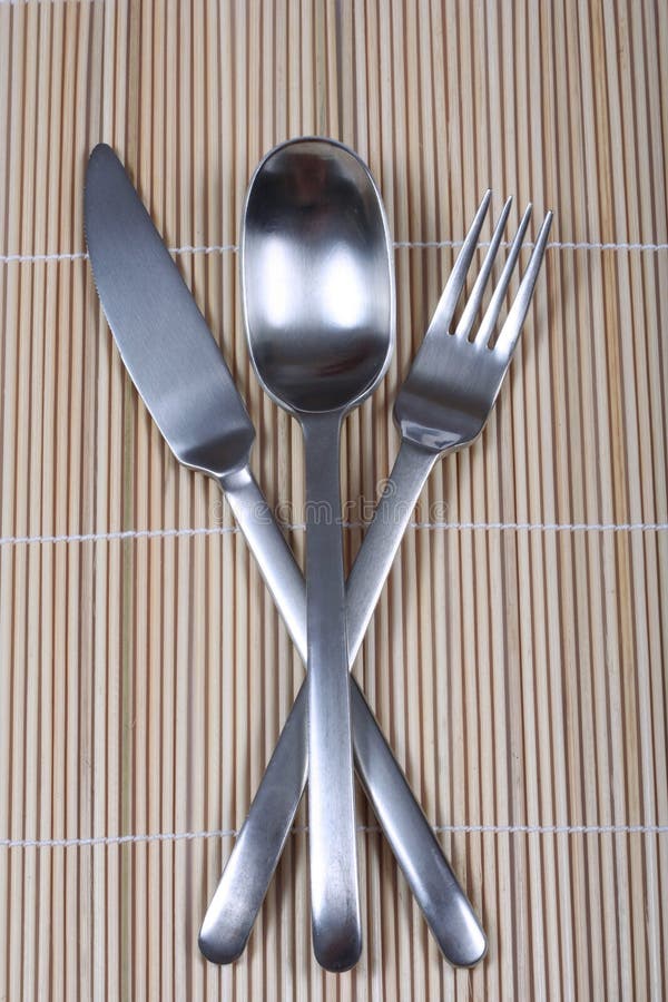 Fork knife and spoon on bamboo