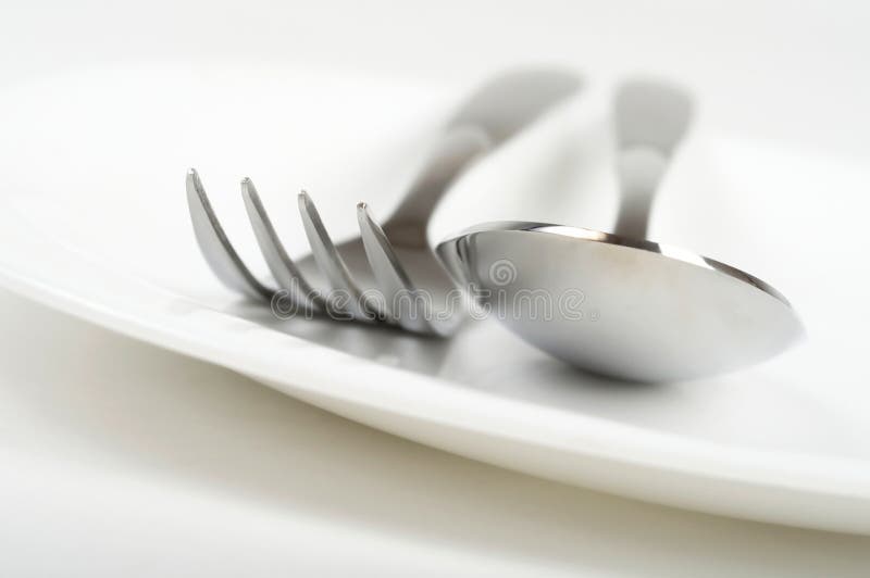 Fork and spoon on plate stock photo. Image of dishware 8799036