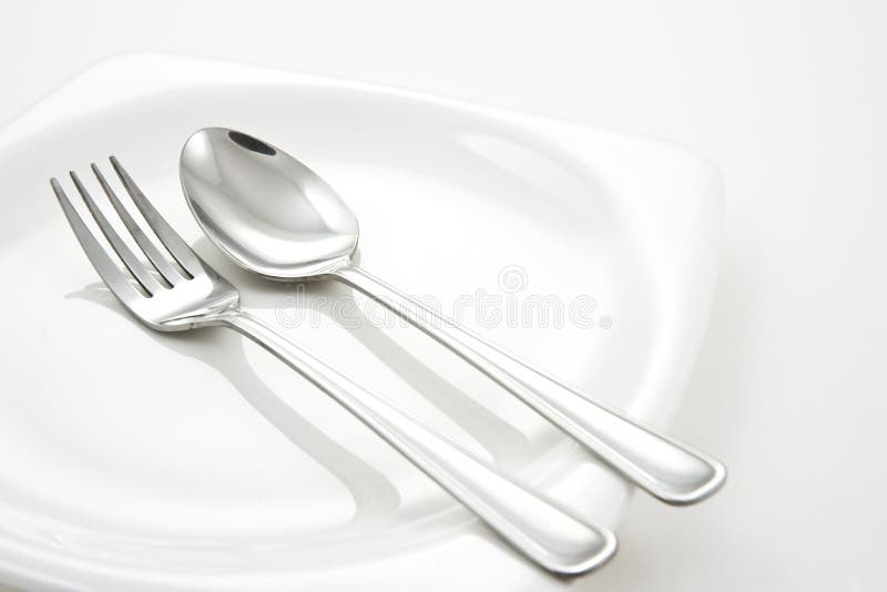 Fork and Spoon on White Plate Stock Image Image of isolated, metal