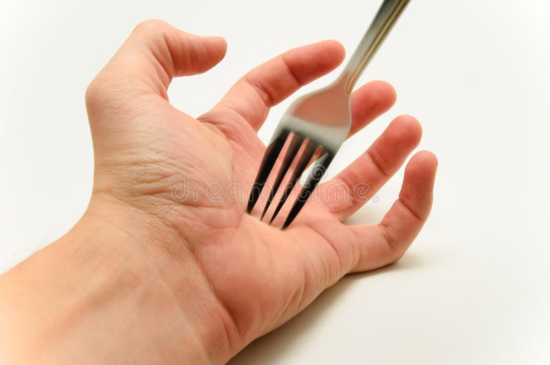 Fork stabbing a hand palm on white background stock image Fork stabbing a hand palm on white background stock image