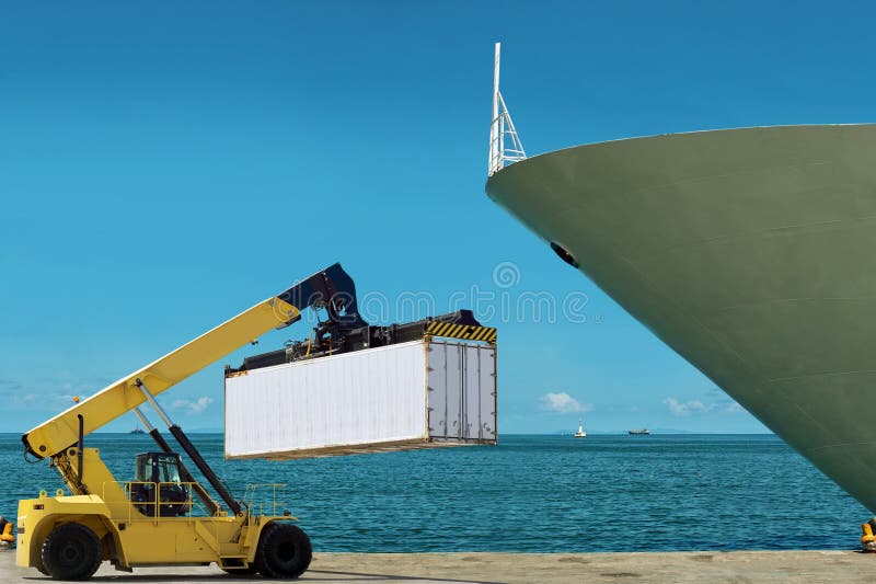 Forklift is loading cargo containers in the port.The docked ship, sea, sky as background. The area of the beautiful blue sky is free for your text. Forklift is loading cargo containers in the port.The docked ship, sea, sky as background. The area of the beautiful blue sky is free for your text.