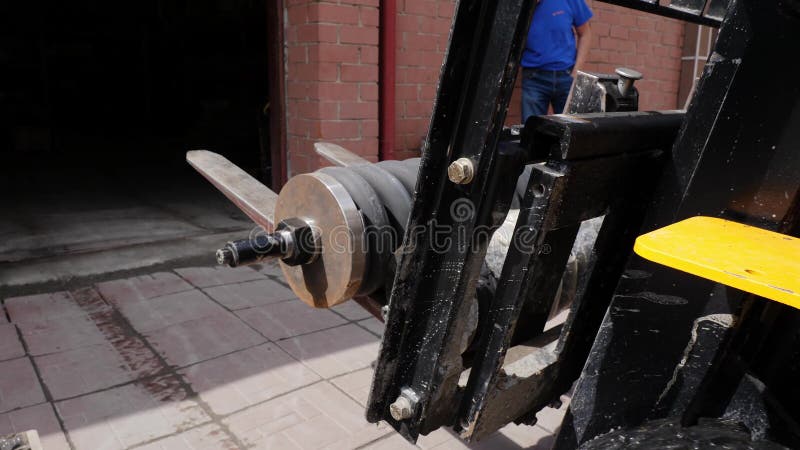 Forklift driver in protective vest driving forklift at warehouse of freight forwarding company. Man on the forklift stock video