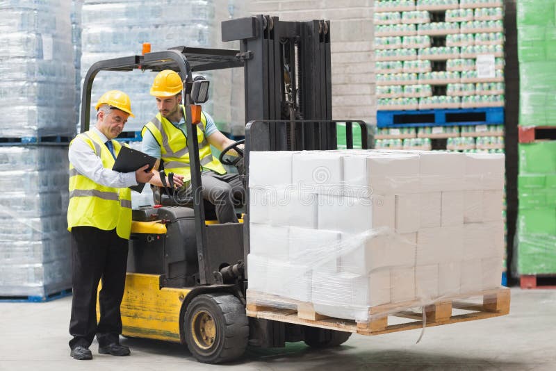 Forklift driver talking with his manager royalty free stock photography Forklift driver talking with his manager royalty free stock photography