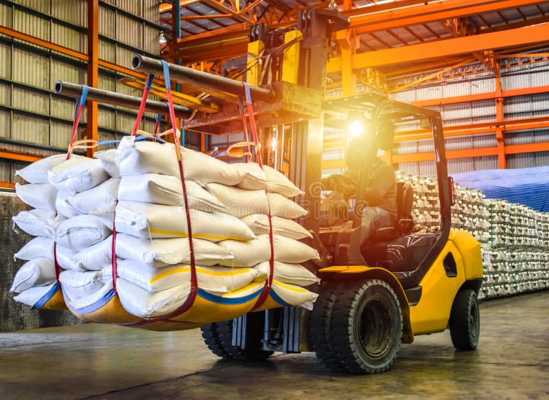 Forklift handling sugar bag for stuffing into container for export.