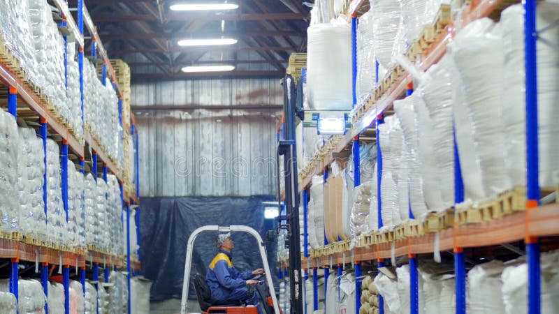 Forklift loading large sacks of grain in stock stock video