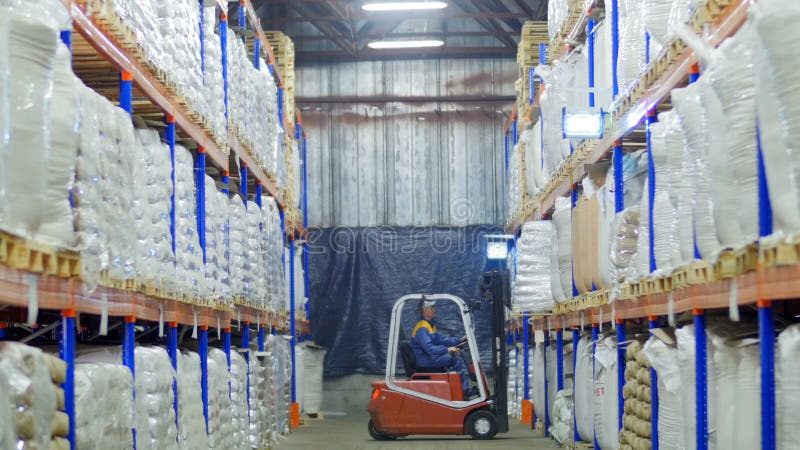 Forklift loading large sacks of grain in stock stock footage