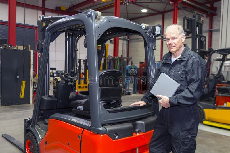 Forklift Mechanic with Clip Board Stock Image Image of friendly