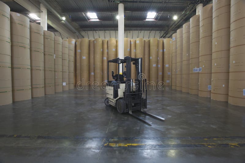 Forklift Truck And Huge Rolls Of Paper In Factory